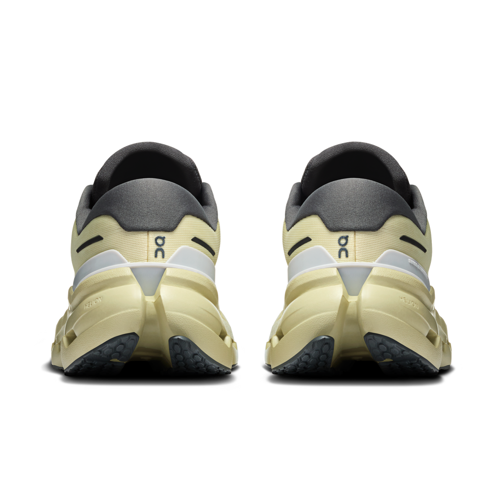 Women's waterproof running shoes, pale yellow heel with dark gray collar and lace closure.