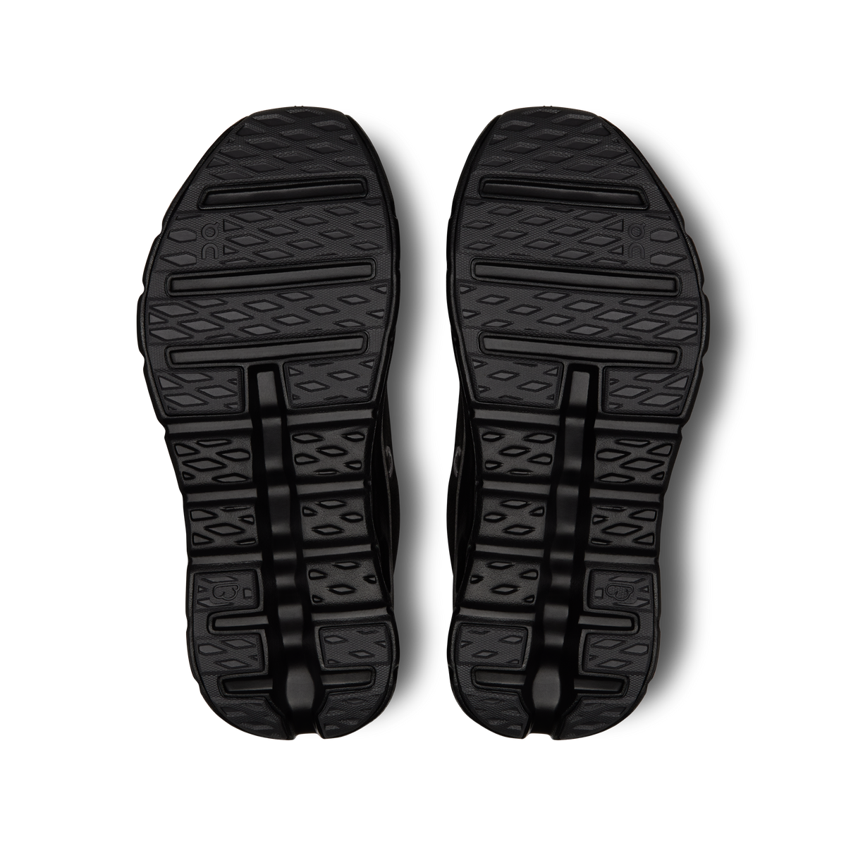 Black outsole tread pattern on women's running shoes, bottom view