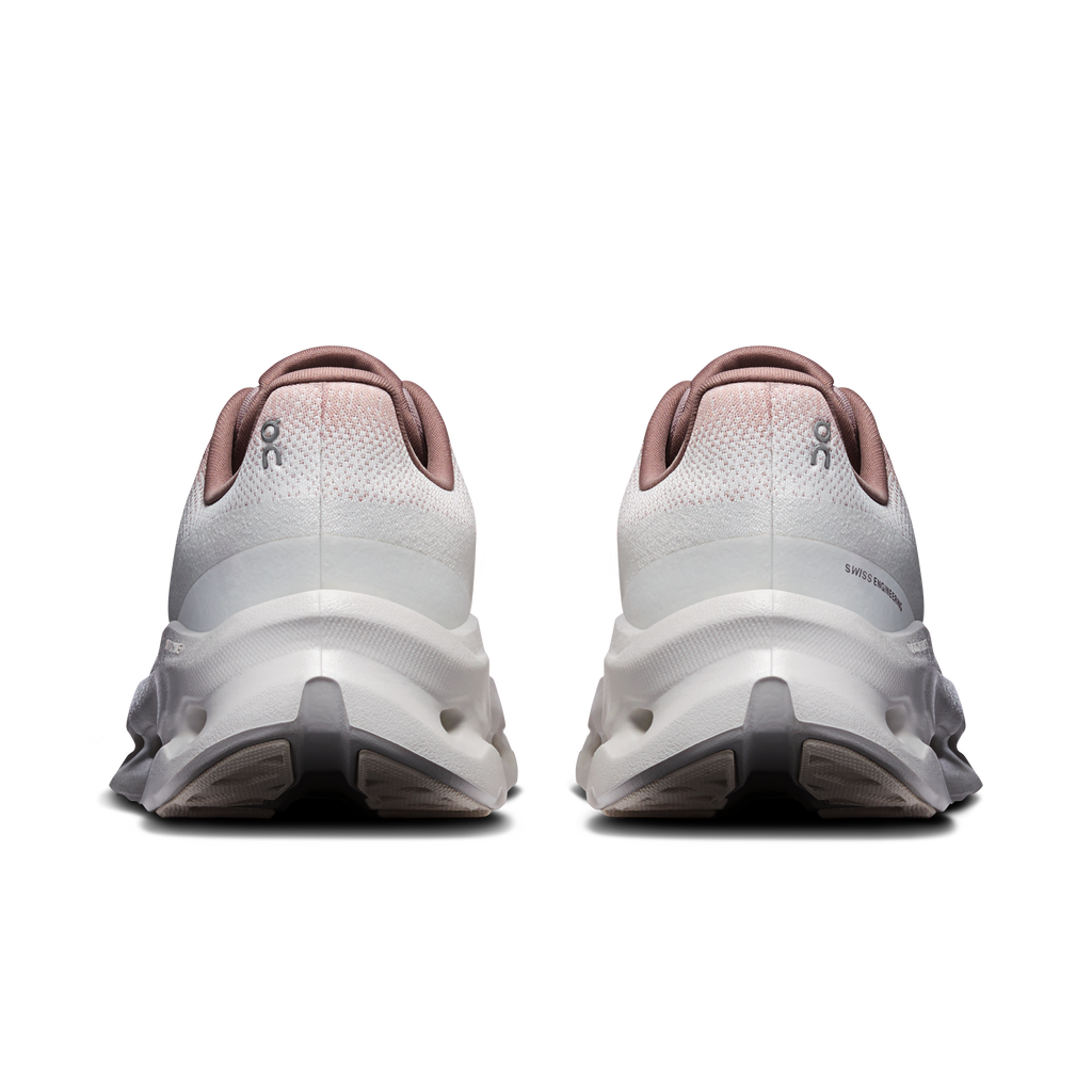Women’s running shoes back view in ivory with pink heel collar and molded heel