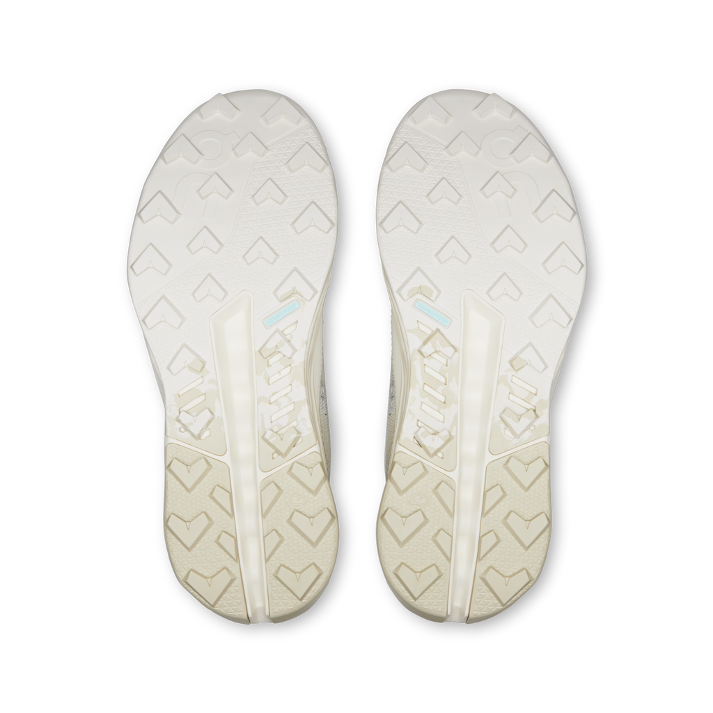 Pair of shoe outsoles with patterned tread, light ivory waterproof running shoes