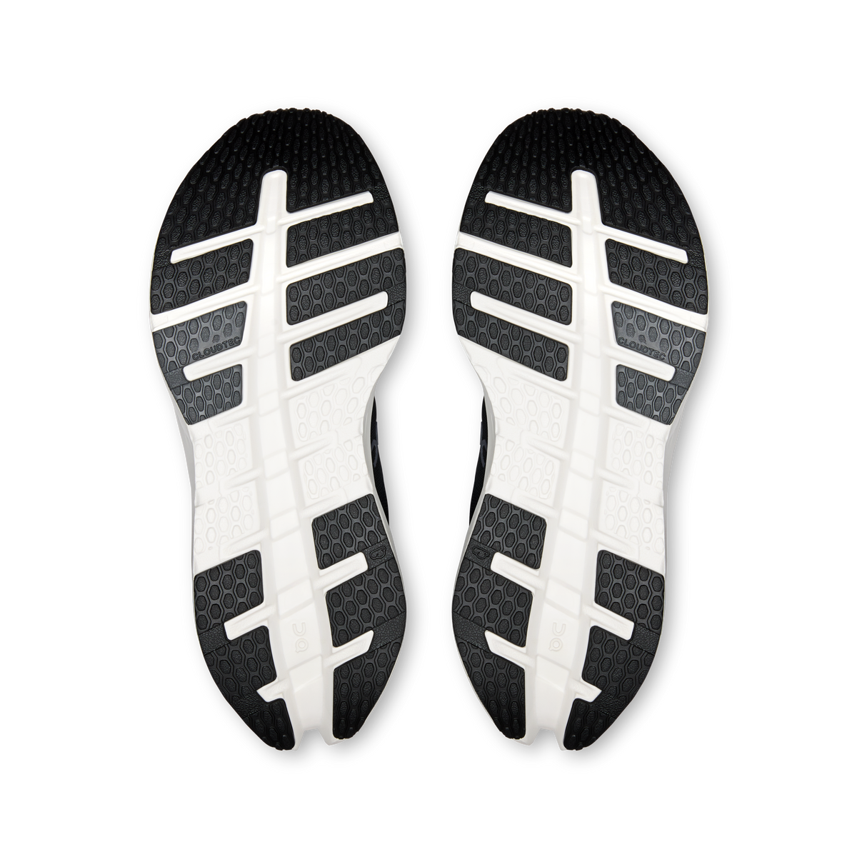 Pair of black outsoles with white cross tread and grid pattern traction.