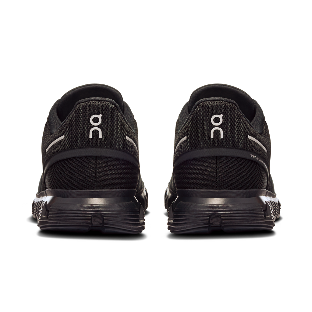 Men's wide running shoes in black, back view with heel tabs and On logos