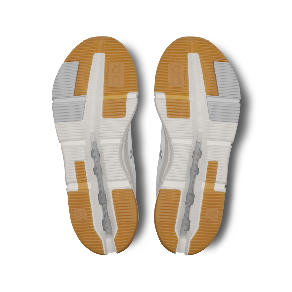 Pair of shoe outsoles, white with orange grip areas and segmented traction grooves