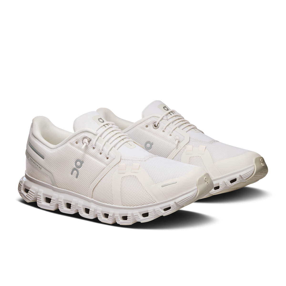 Women's white wide lace-up running shoes with padded tongue and On logo