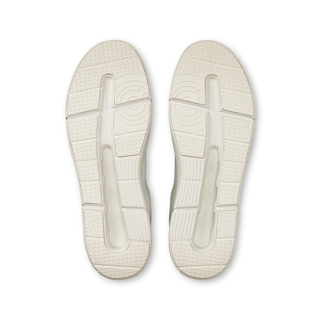 Pair of white shoe soles with molded traction pattern and heel cushioning