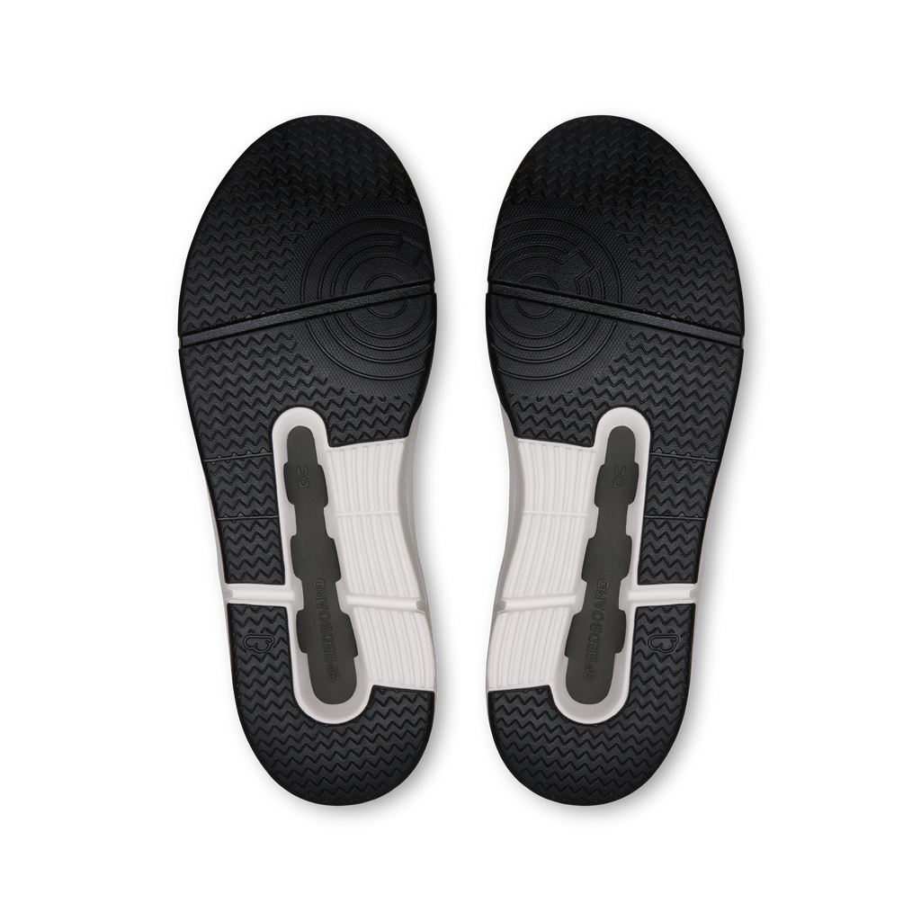 Black rubber outsole with textured tread and cushioned U-shaped traction pads