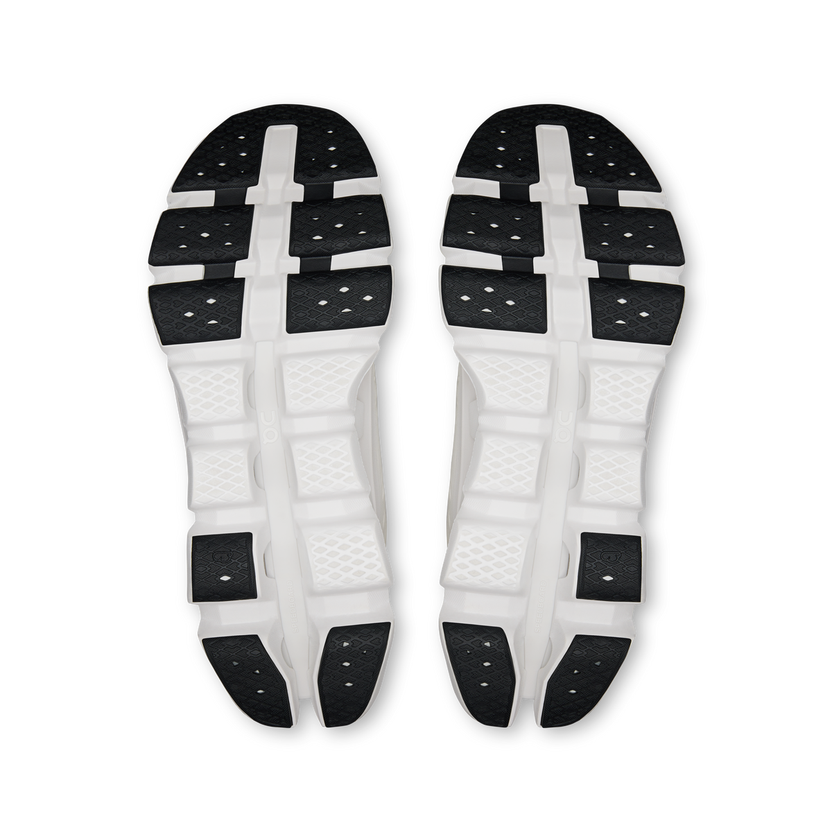Shoe outsole view: white rubber sole with black grip pads and central support bridge