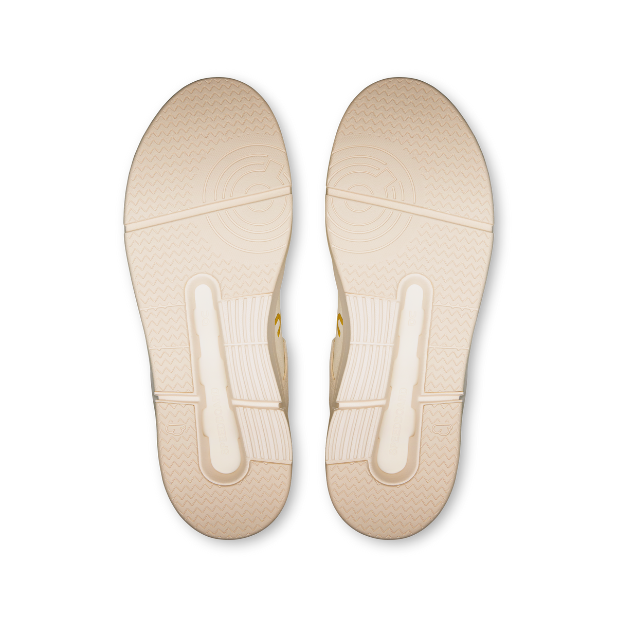 Pair of ivory shoe outsoles with textured tread and side traction grooves