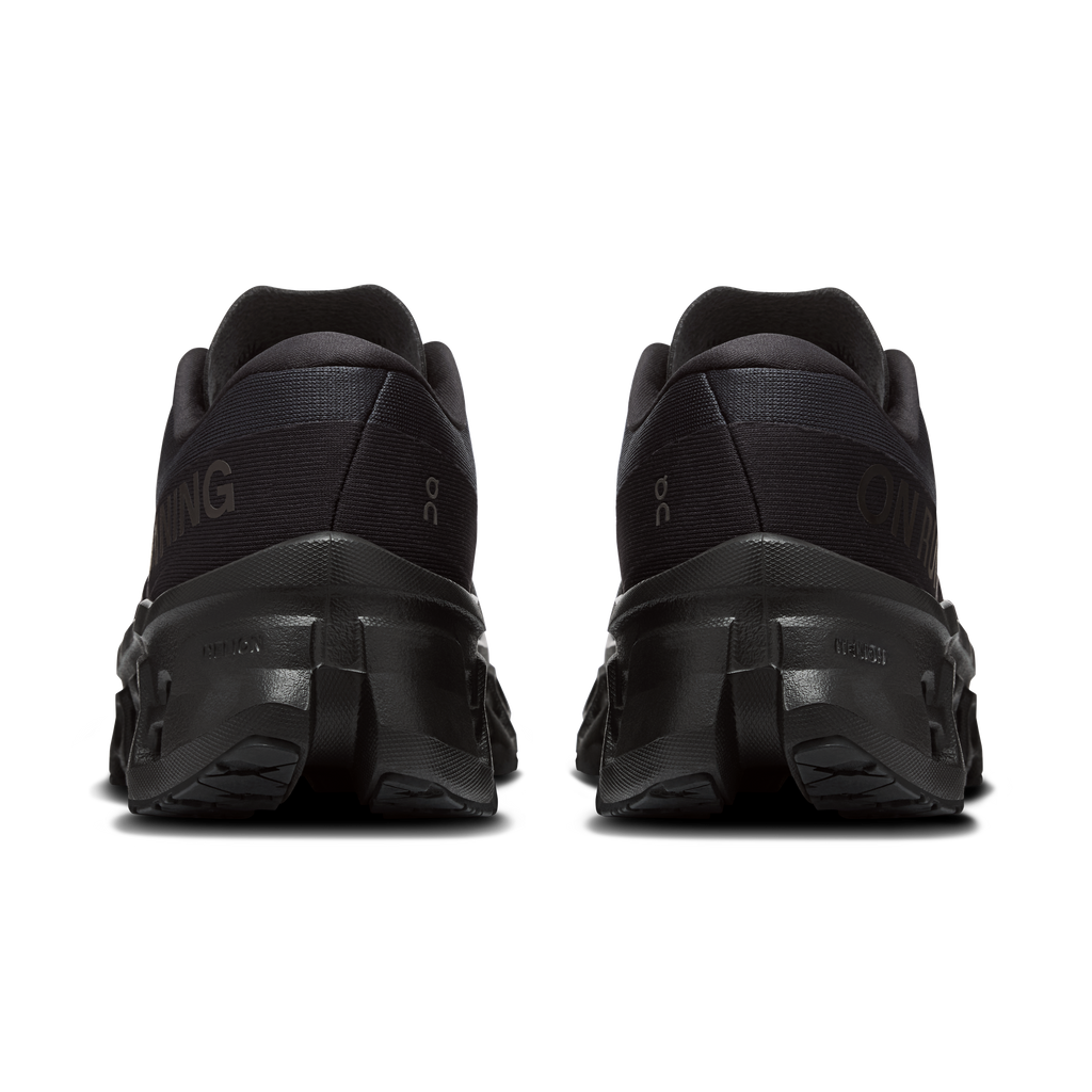 Women's black running shoes, back view, padded heel and lace-up closure