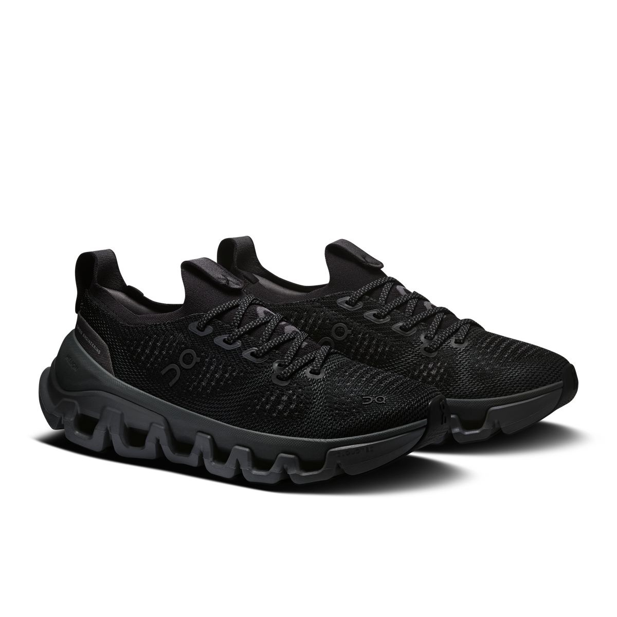 Pair of black knit lace-up running shoes with chunky treaded outsole and Cloud-style pods