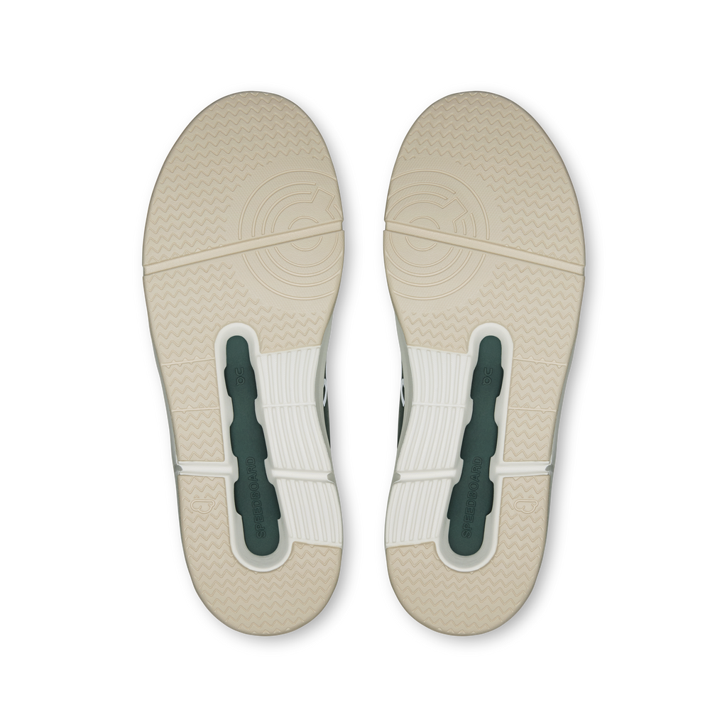 Women's sneaker outsole in light beige with dark heel inserts and traction pattern