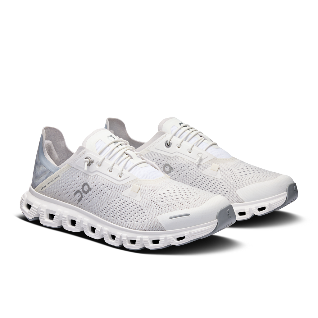 Pair of women's white lace-up running shoes, side view with cushioned Cloud pod sole