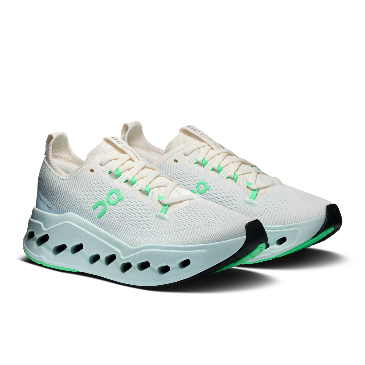 Women’s running shoes, ivory upper with green laces, light-blue sole, side cloud cutouts