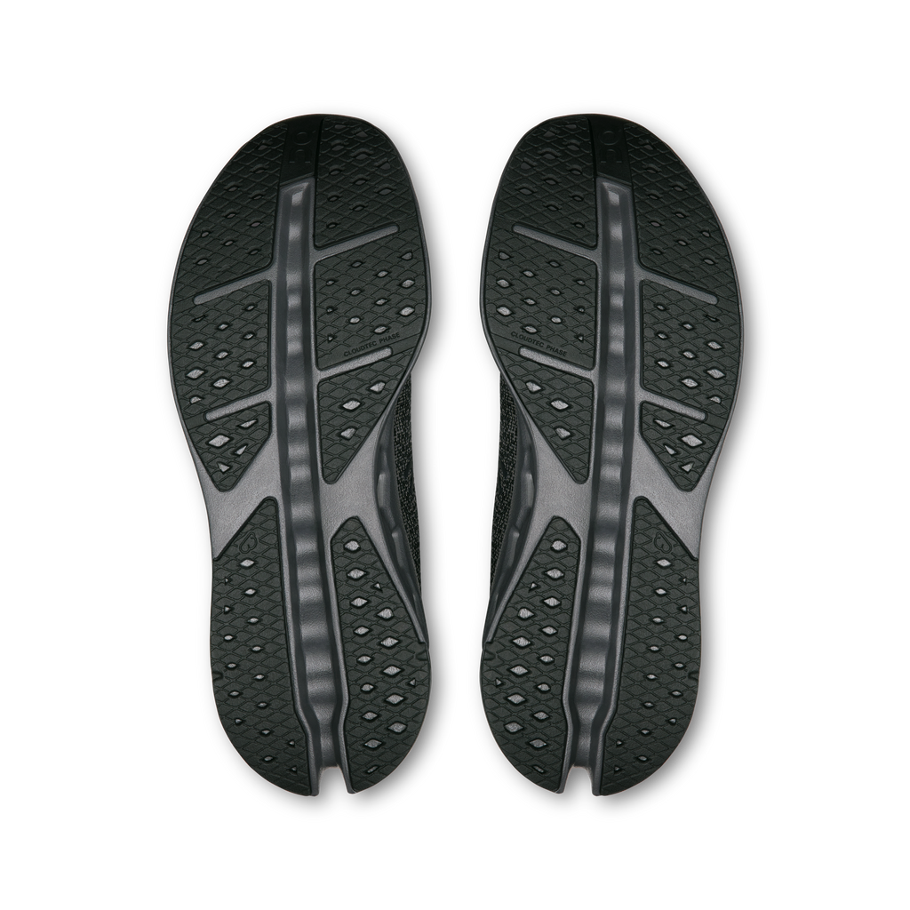 Pair of shoe outsoles with patterned traction pods and central rib
