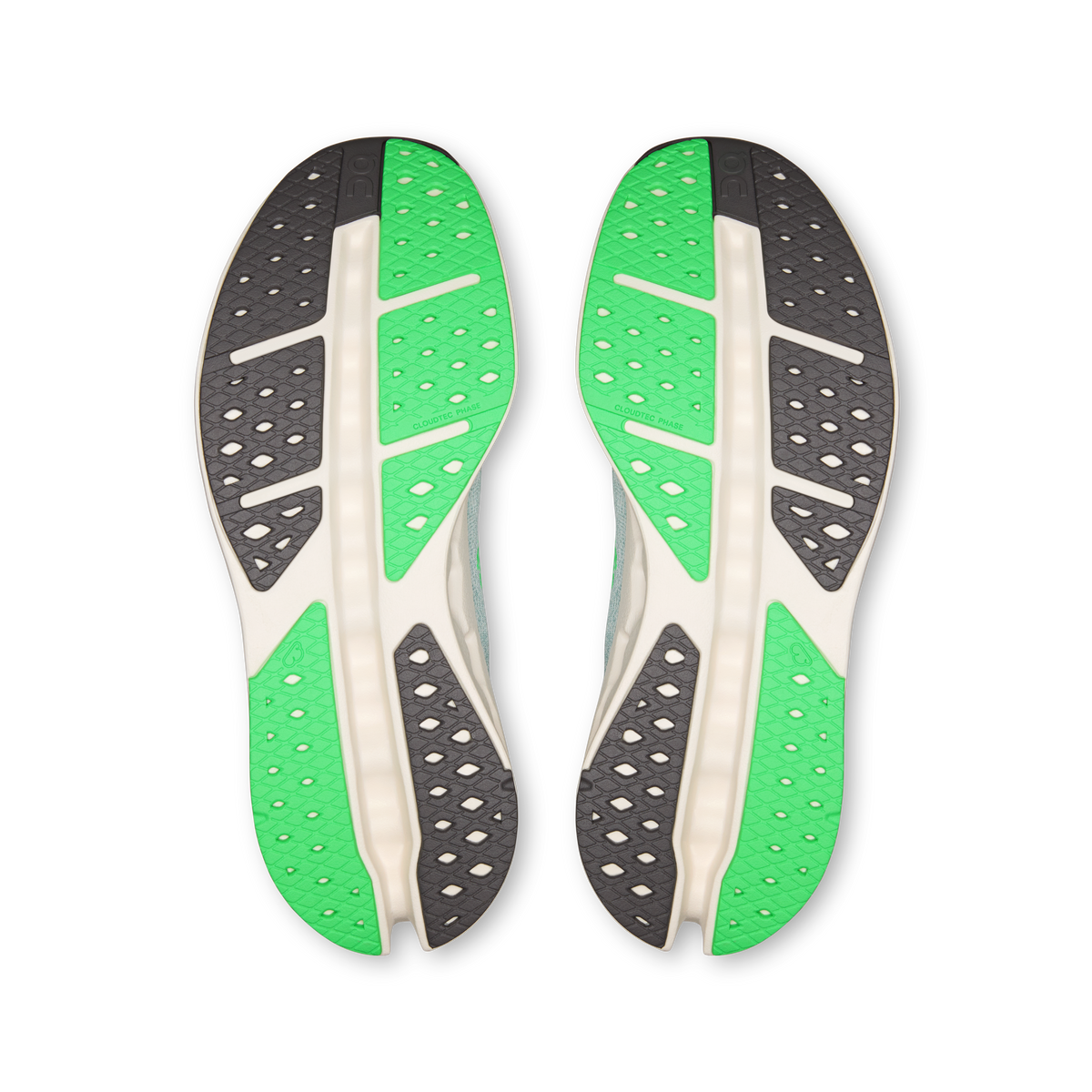 Shoe outsole pair with green tread panels and patterned rubber for grip