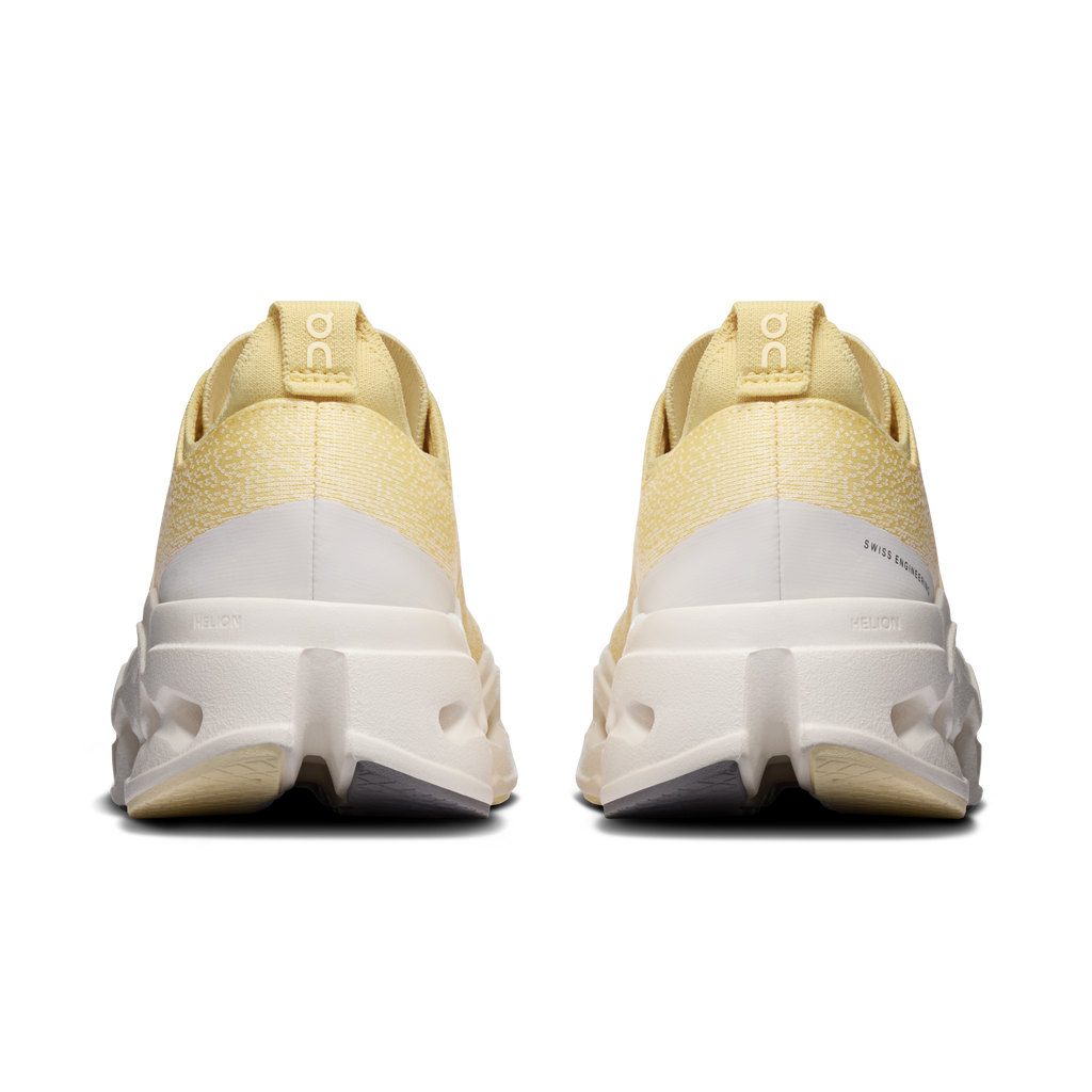 Women's yellow running shoes rear view with white heel and gray outsole detailing