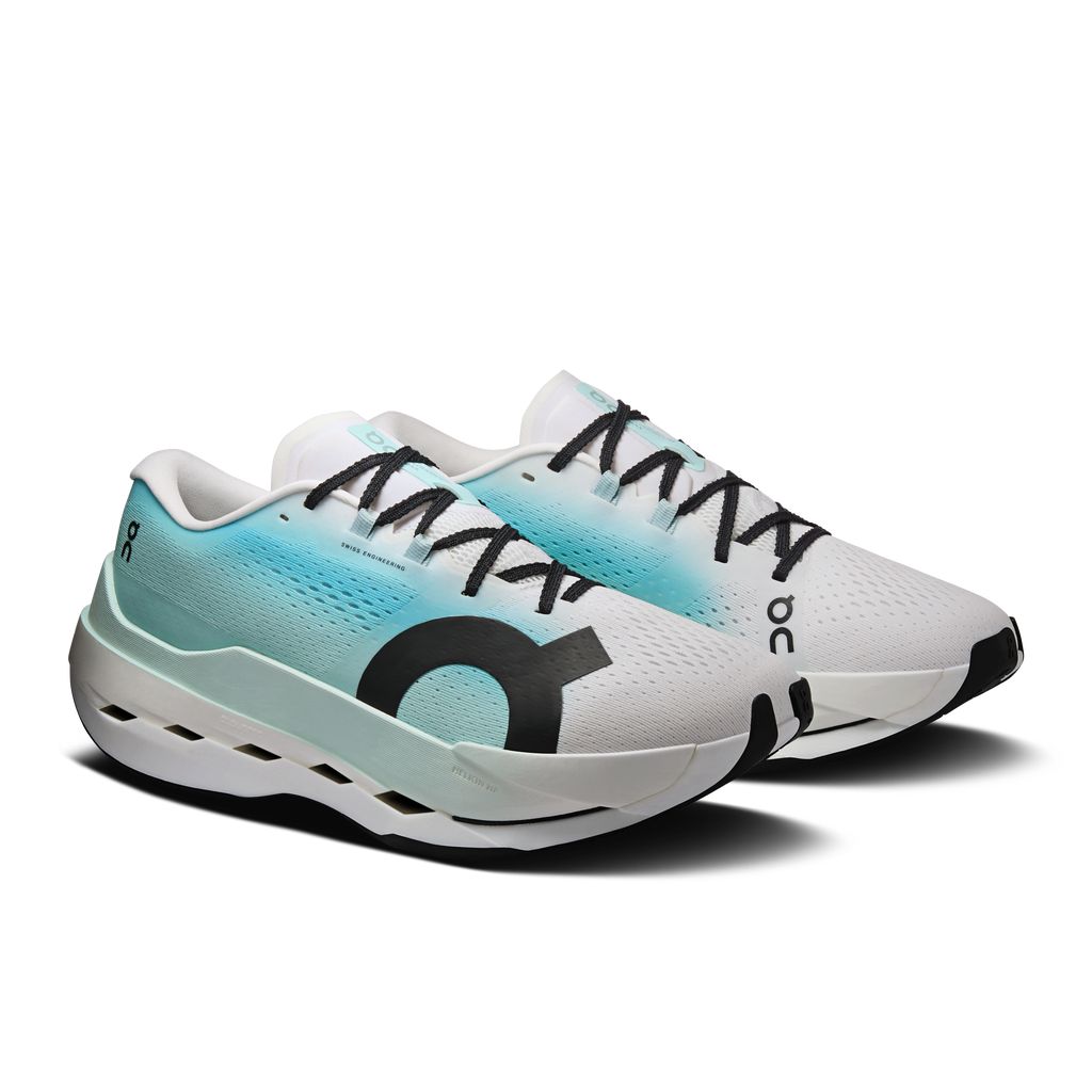 Men's white and teal running shoes with black laces, side logo, and foam sole