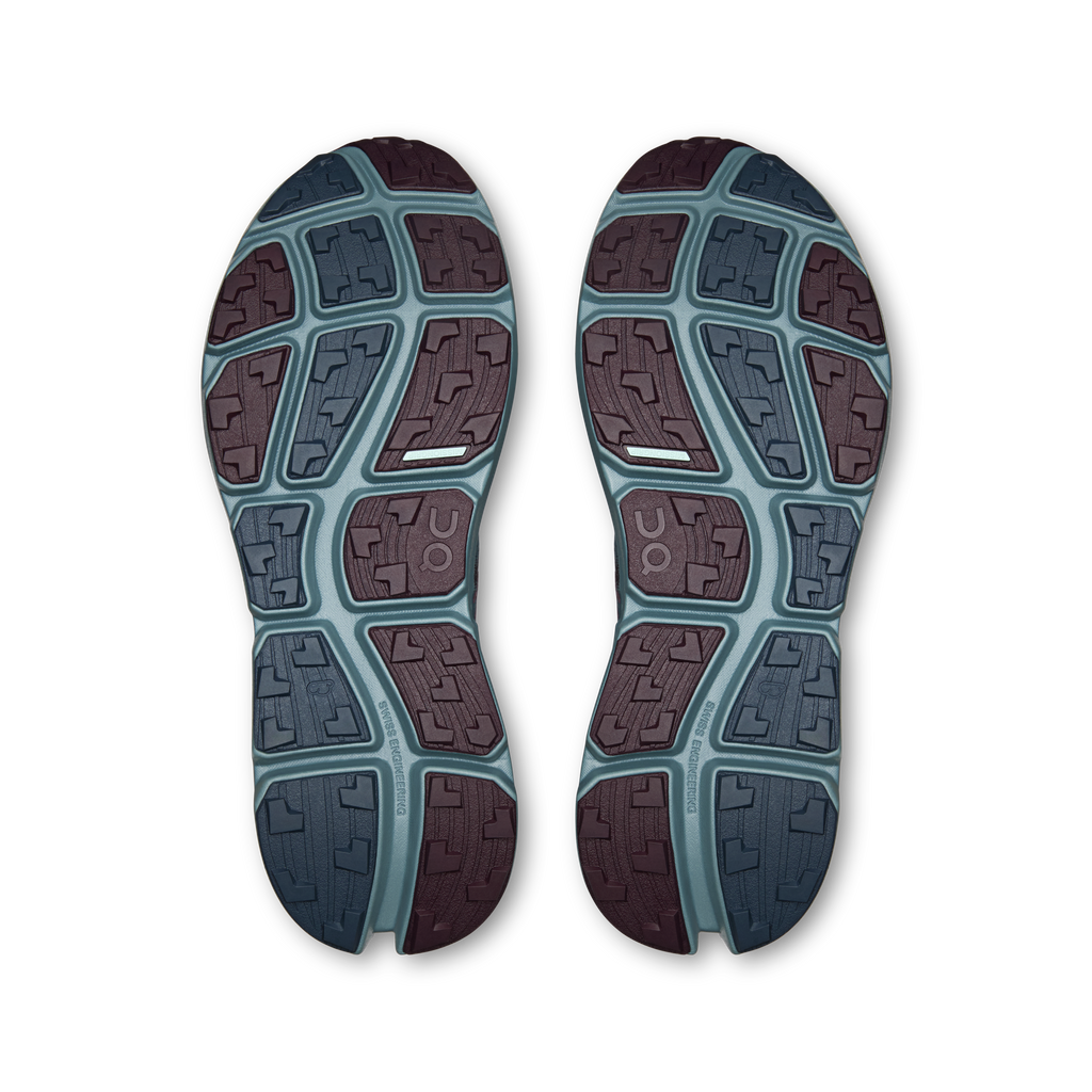 Pair of shoe outsoles with geometric tread in blue and maroon rubber sections