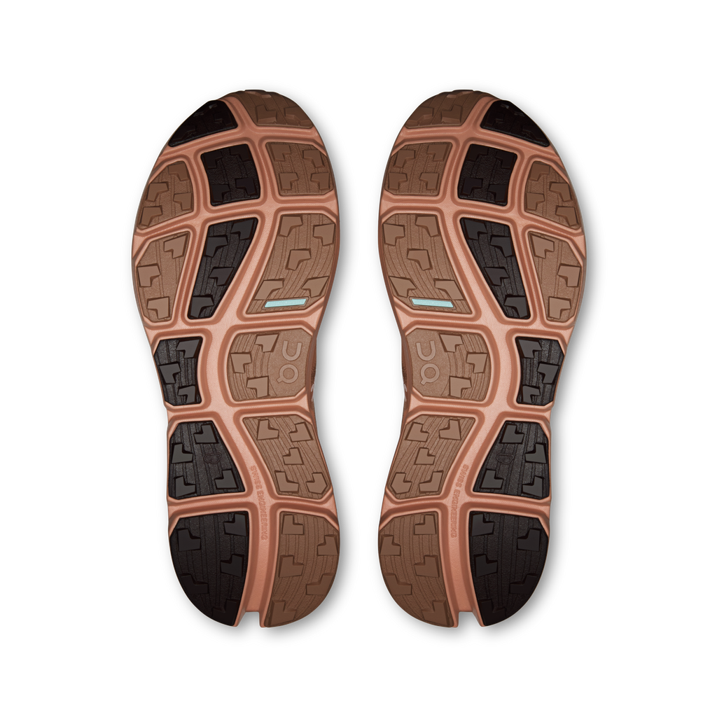 On men's running shoes outsole view with rugged traction tread, tan and dark rubber