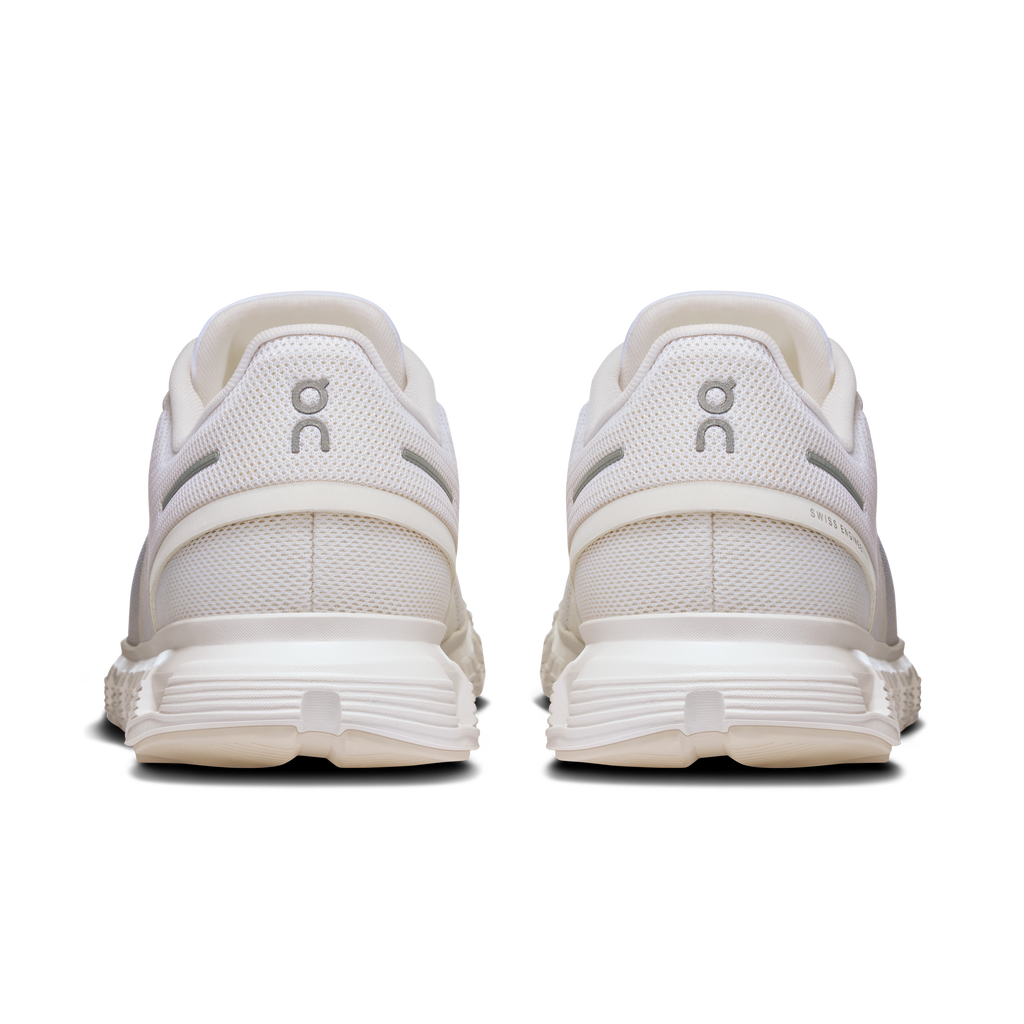 Women's white wide running shoes, rear view with padded heel and lace eyelets