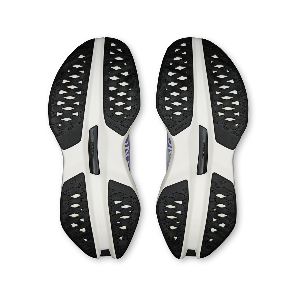 On running shoe outsoles with black tread pattern and white supportive plates