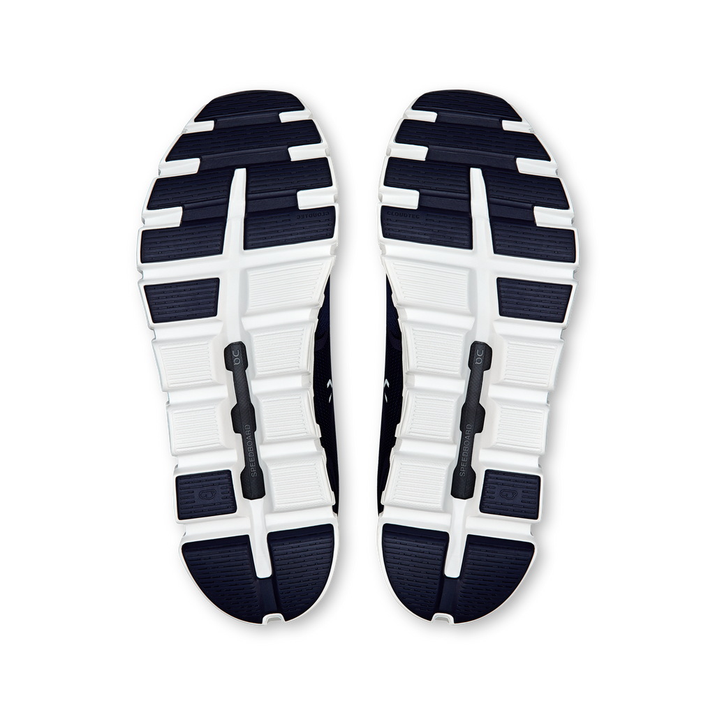 Pair of navy-and-white shoe outsoles with tread pods and On branding