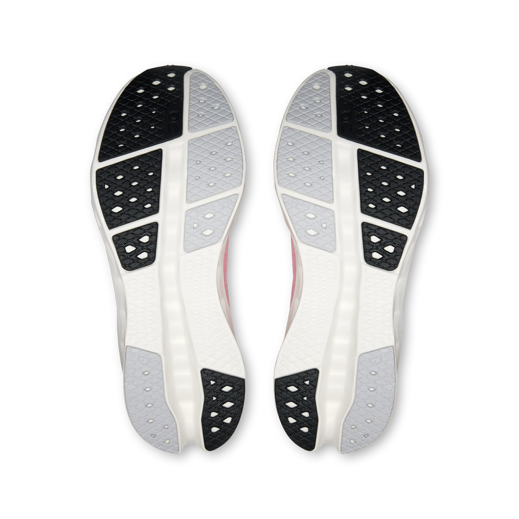 Pair of women's On Cloudsurfer 2 shoes outsole view, black traction pods on light sole