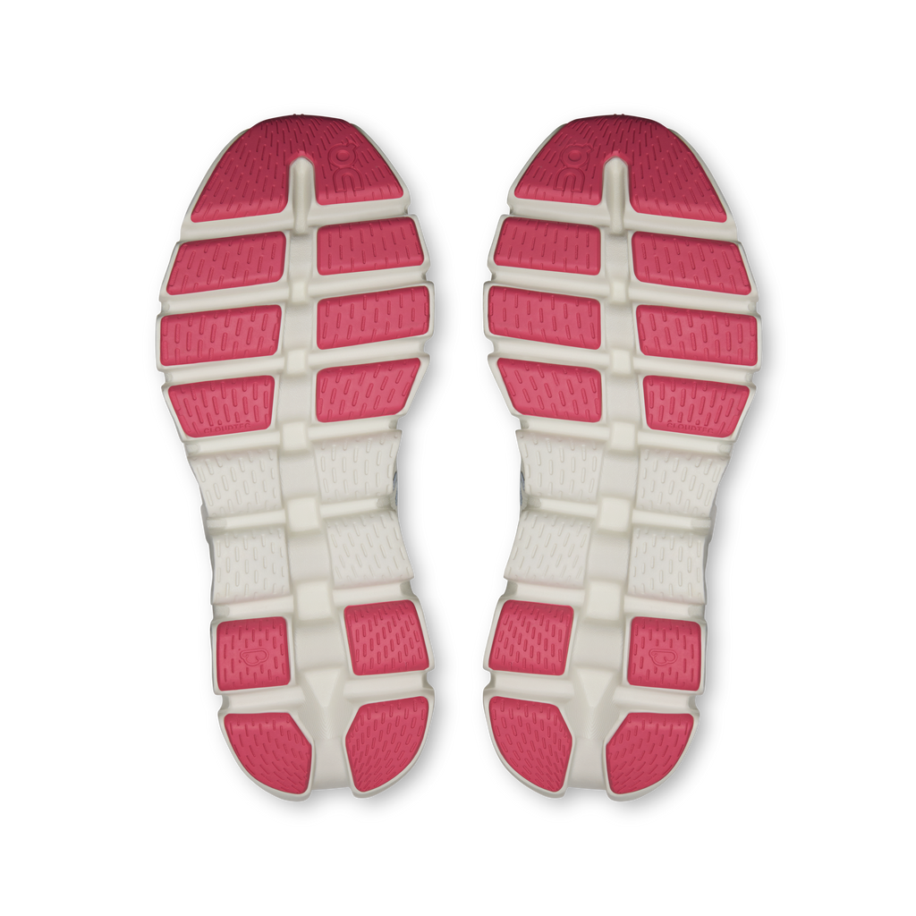 Shoe outsoles pair with red traction pads on white rubber base