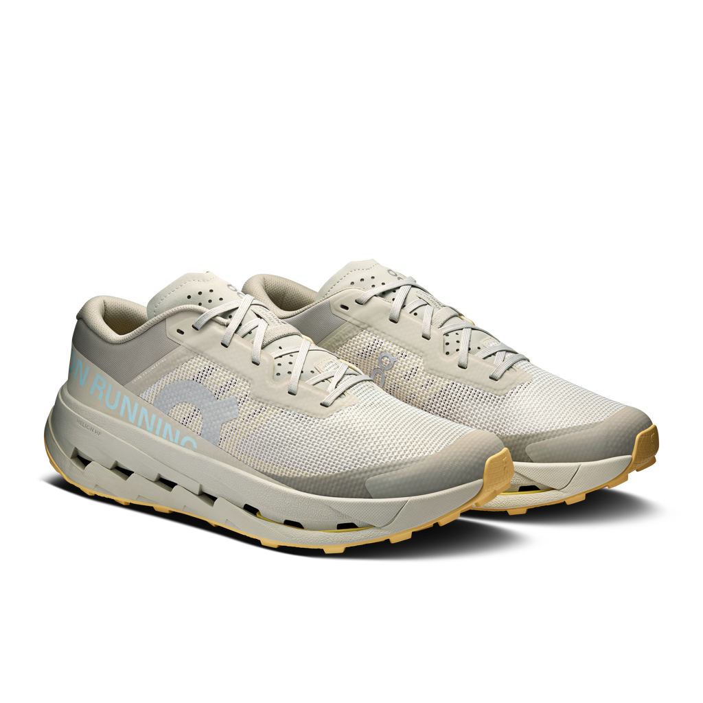 Men's running shoes in light gray with lace-up front and mesh texture, side view