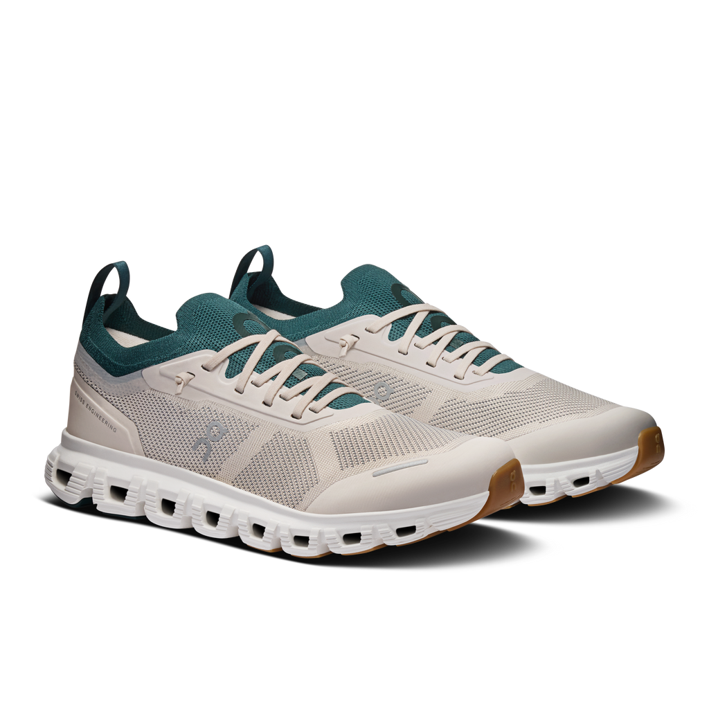 Women's running shoes with pearl knit upper, teal laces, and white Cloud cushioning.