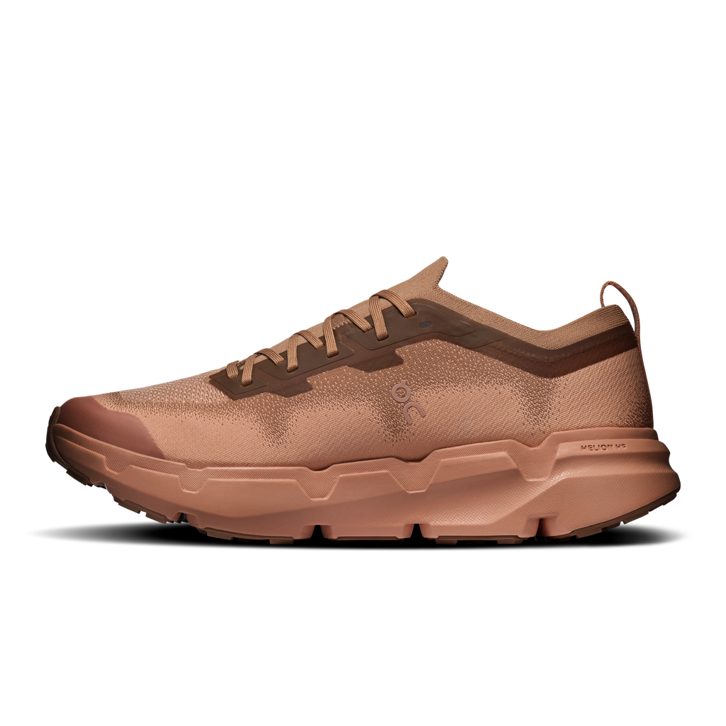 On men's running shoe, heel-to-toe side view, tan-brown upper and cloudlike midsole