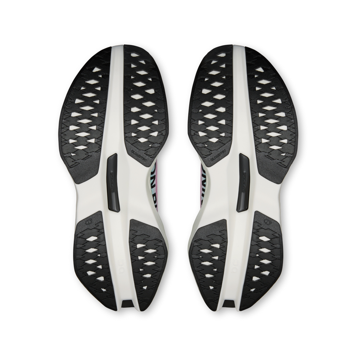 Pair of running shoe outsoles with white and black traction pods