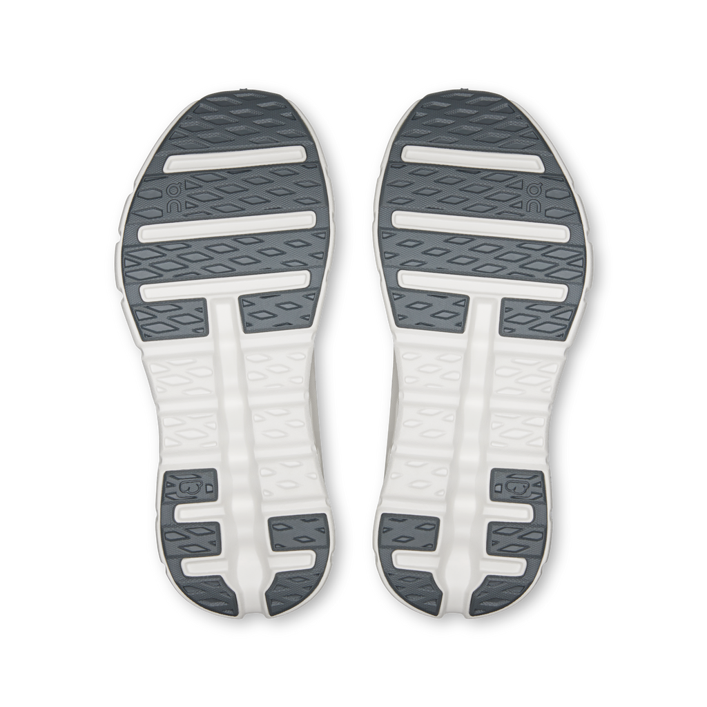 Women’s On running shoe outsoles with gray tread and white cushioning pods