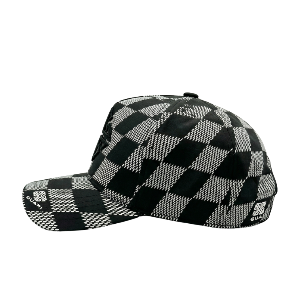 Men's black-and-grey checkerboard cap, side view with small GUAPI patch