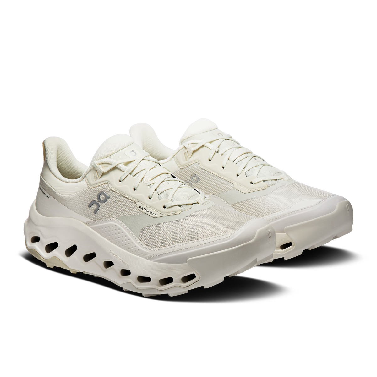 Women's waterproof running shoes, side view with lace-up, ivory upper and cushioned sole