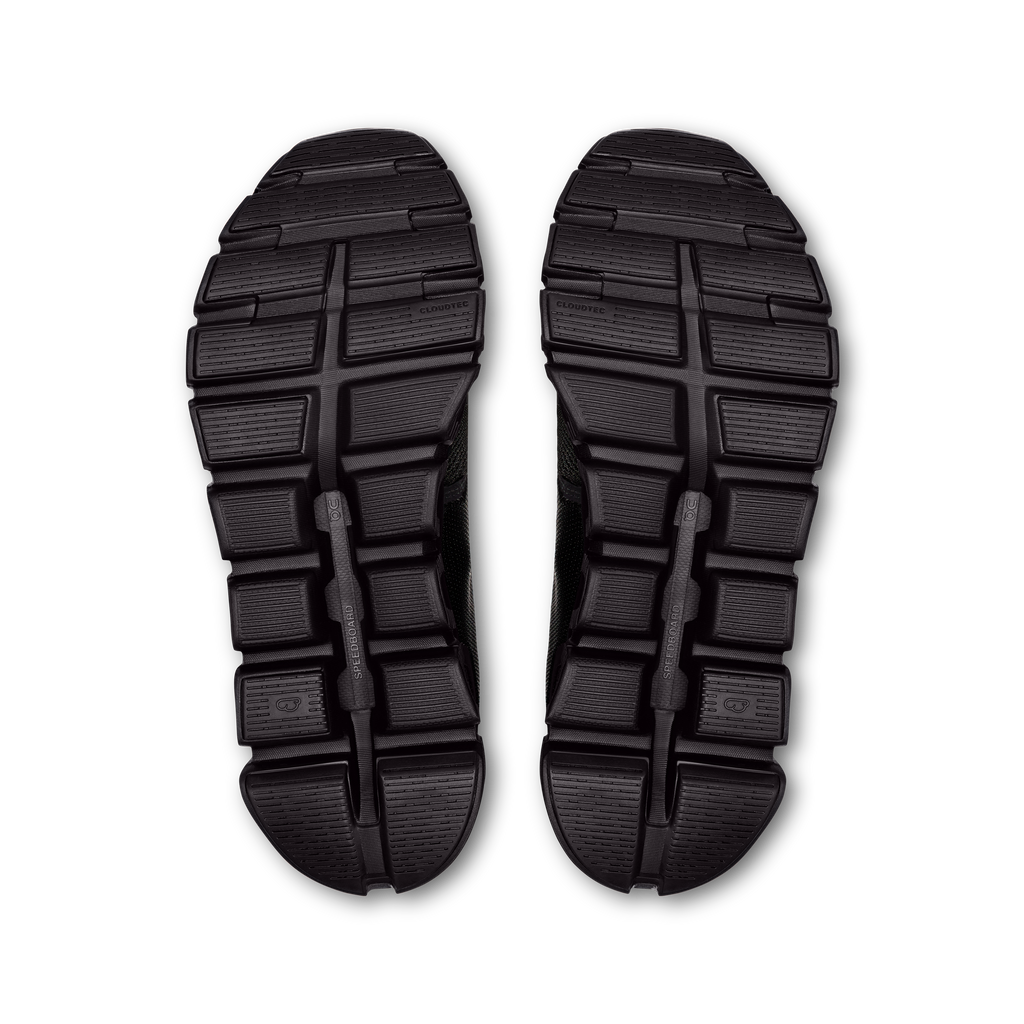 Pair of black outsoles with deep tread and molded traction pods