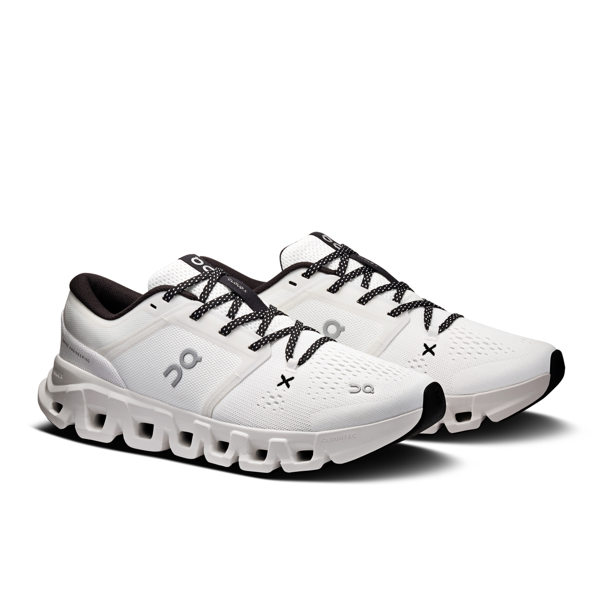 Women's white running shoes angled view with black lace-up and chunky sole