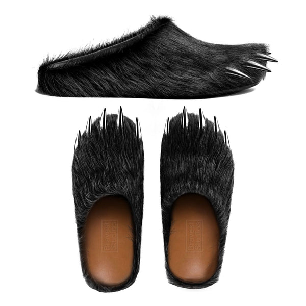 Black faux-fur bear claw mules with metallic spike details, closed-toe slip-ons