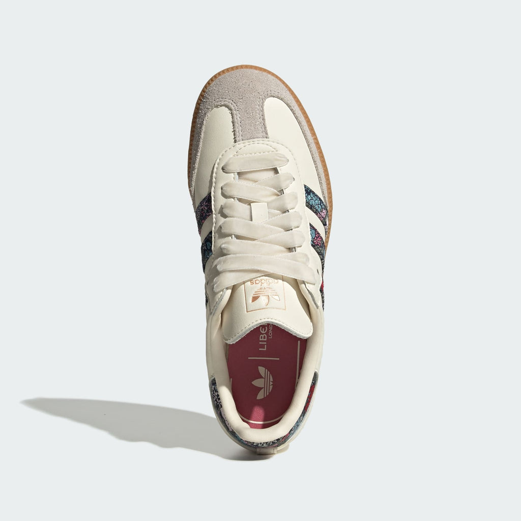 Kids' cream sneakers, front view, with lace-up closure and multicolor heel detail