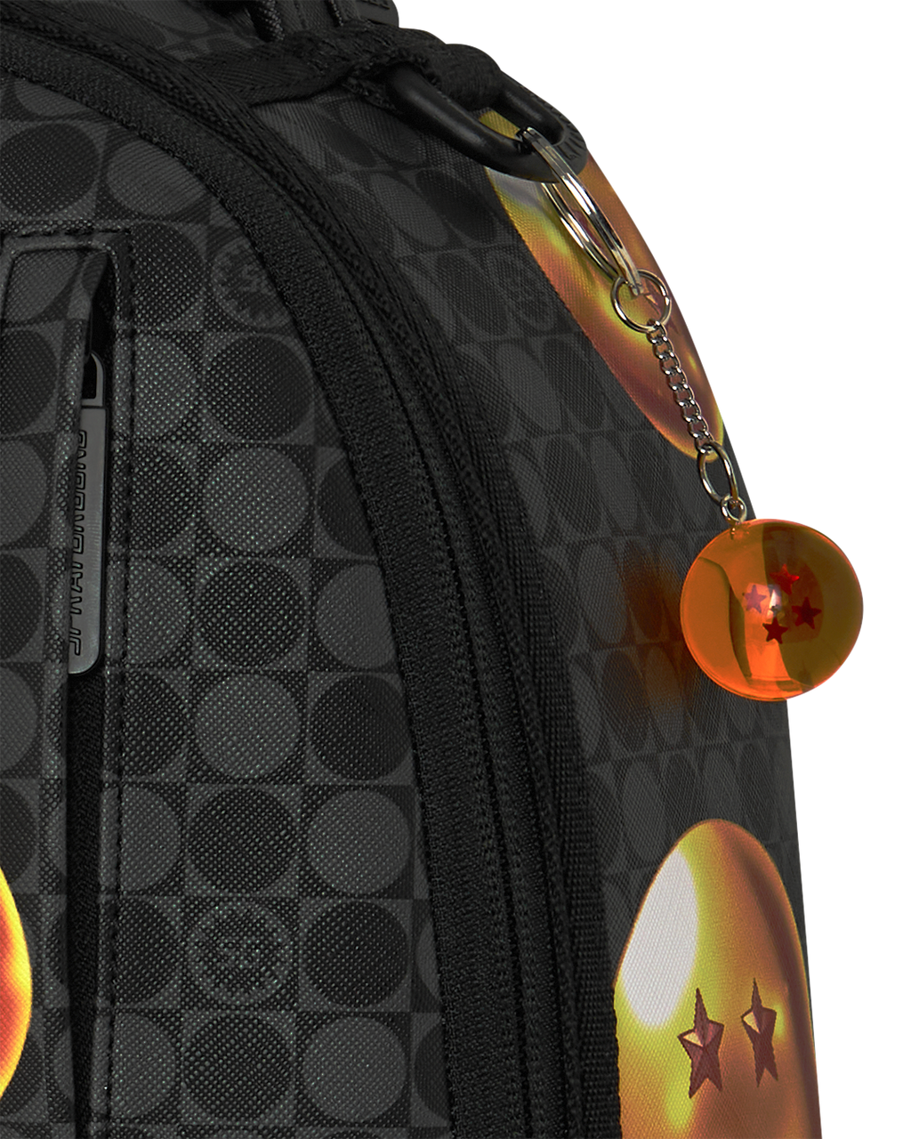Black backpack side panel with textured pattern, zipper, and round orange keychain charm