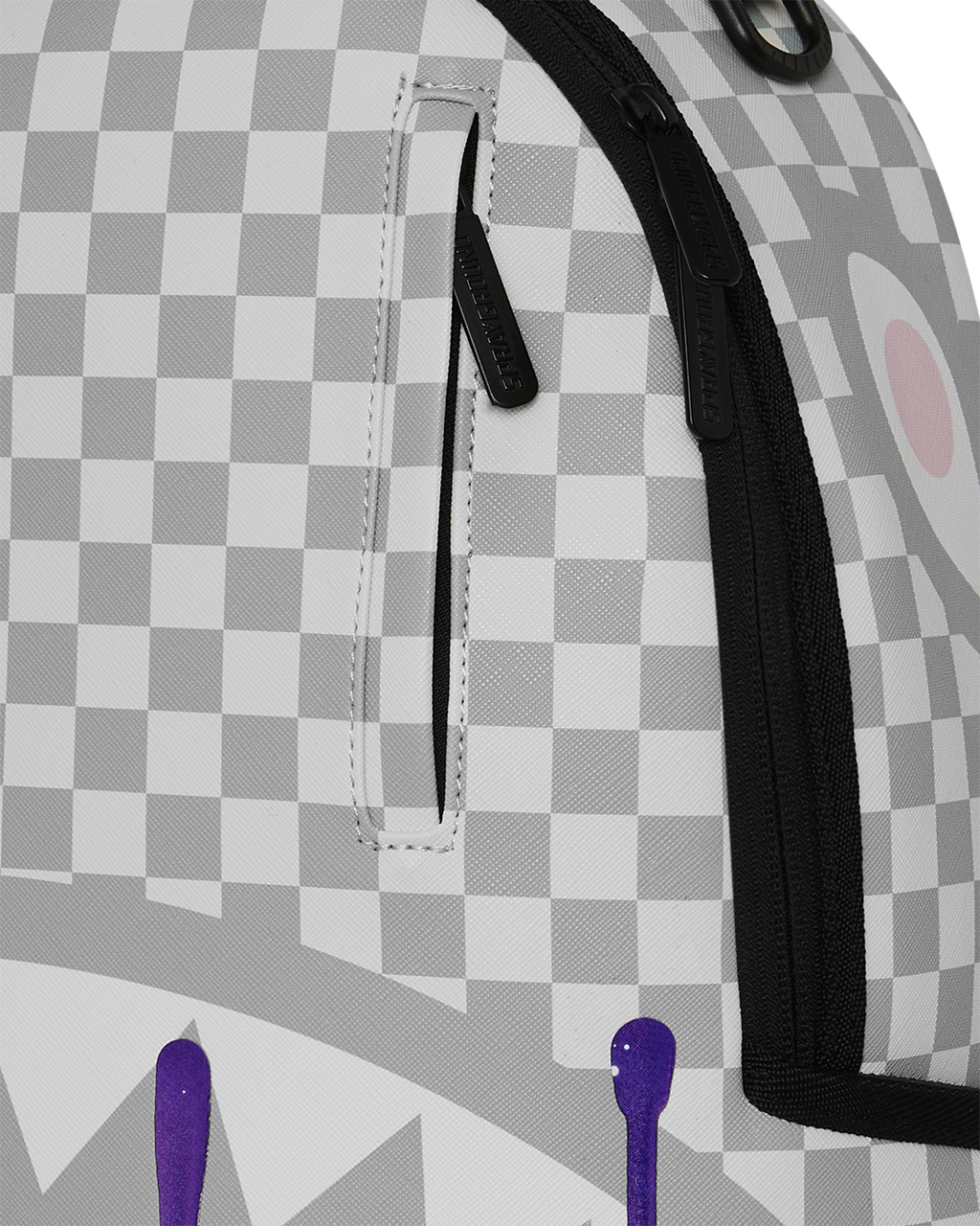 Checkered backpack close-up with black strap and stitched front pocket panel.