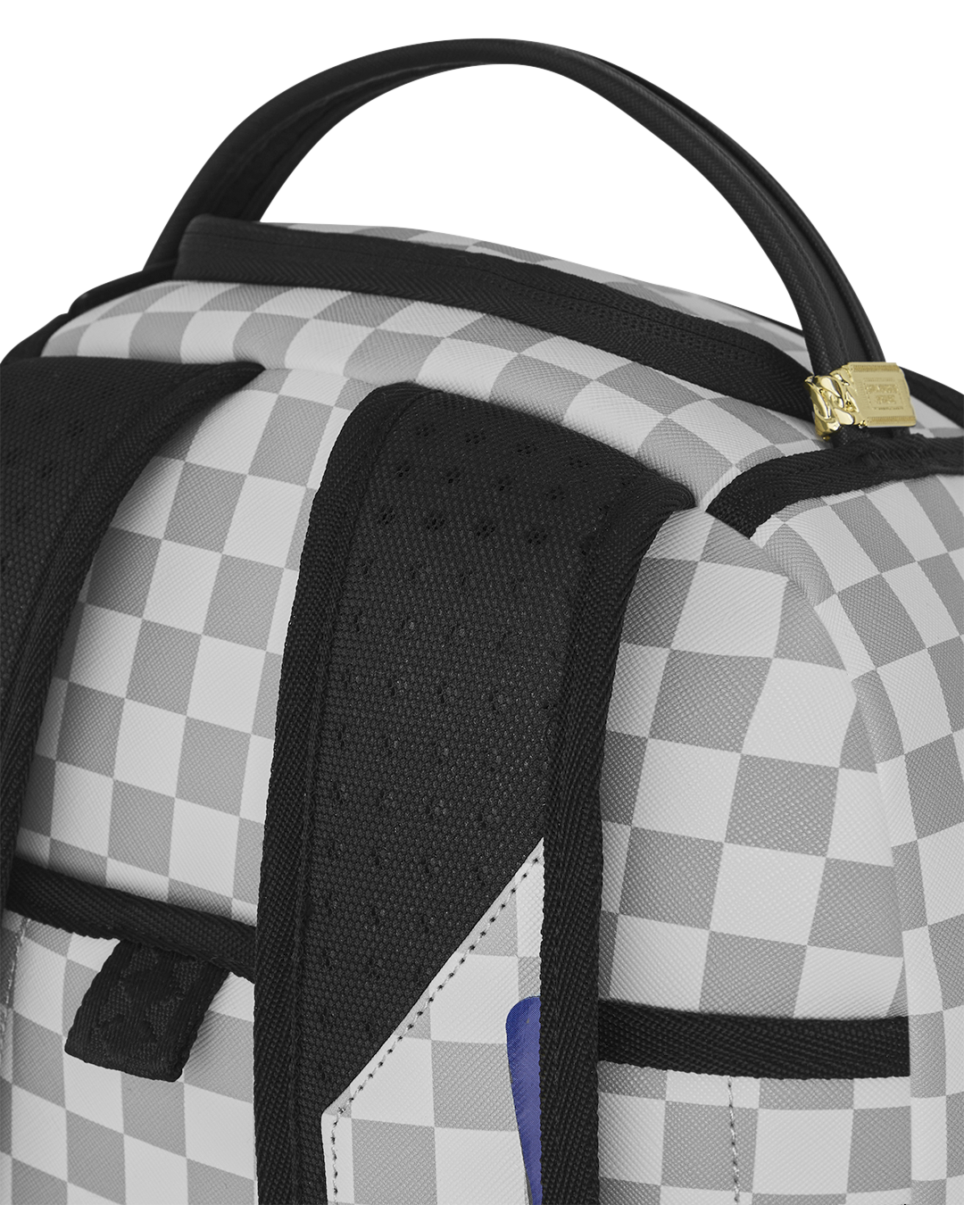 Checkered backpack top with black mesh pocket and gold zipper pull.