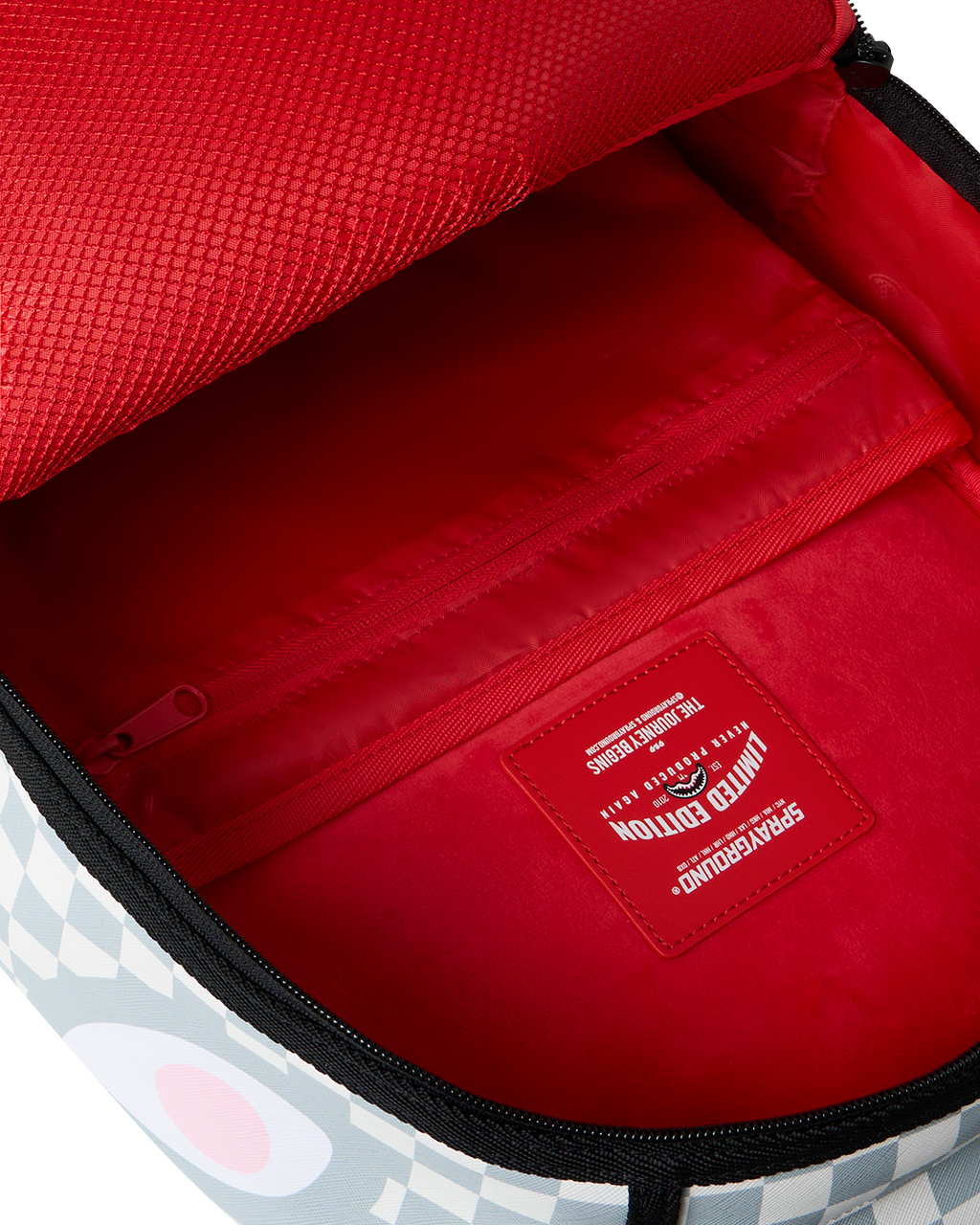 Cosmic Chaos backpack interior with red lining, zipper, and logo patch
