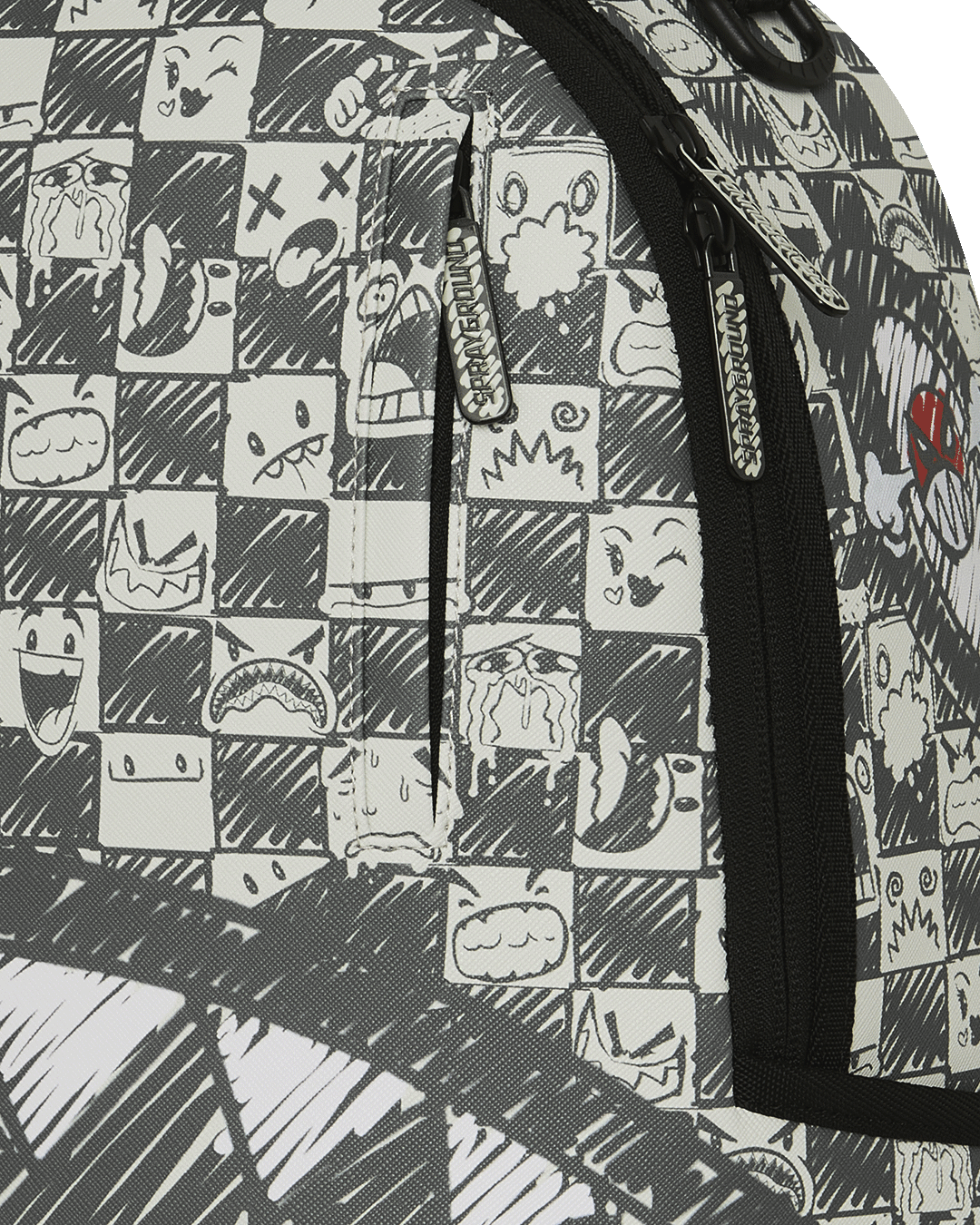 Sprayground backpack fabric close-up with cartoon faces in black-and-white blocks