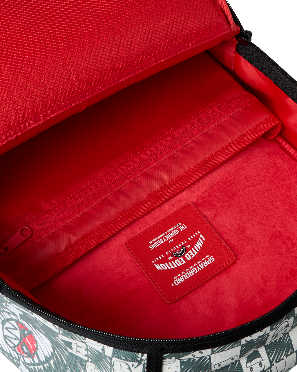 Sprayground backpack interior with bright red lining and brand label