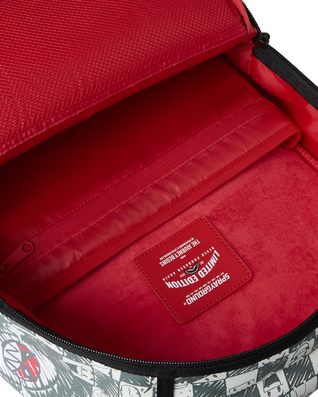 Sprayground backpack interior with bright red lining and brand label