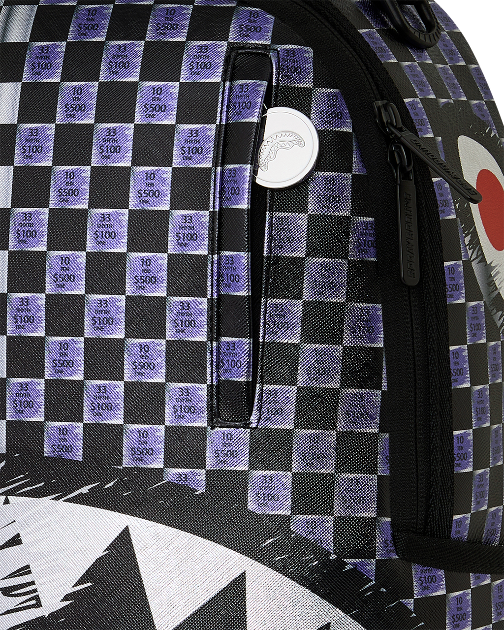 Sprayground shark backpack close-up of checkered fabric with small $100 print and zipper trim
