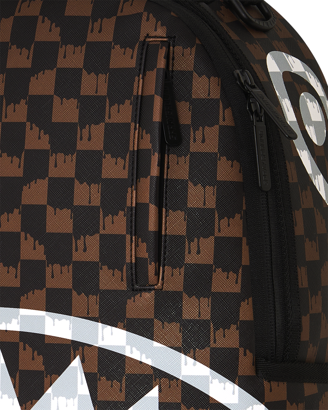 Brown checkered backpack close-up with black zipper and white stripe graphic