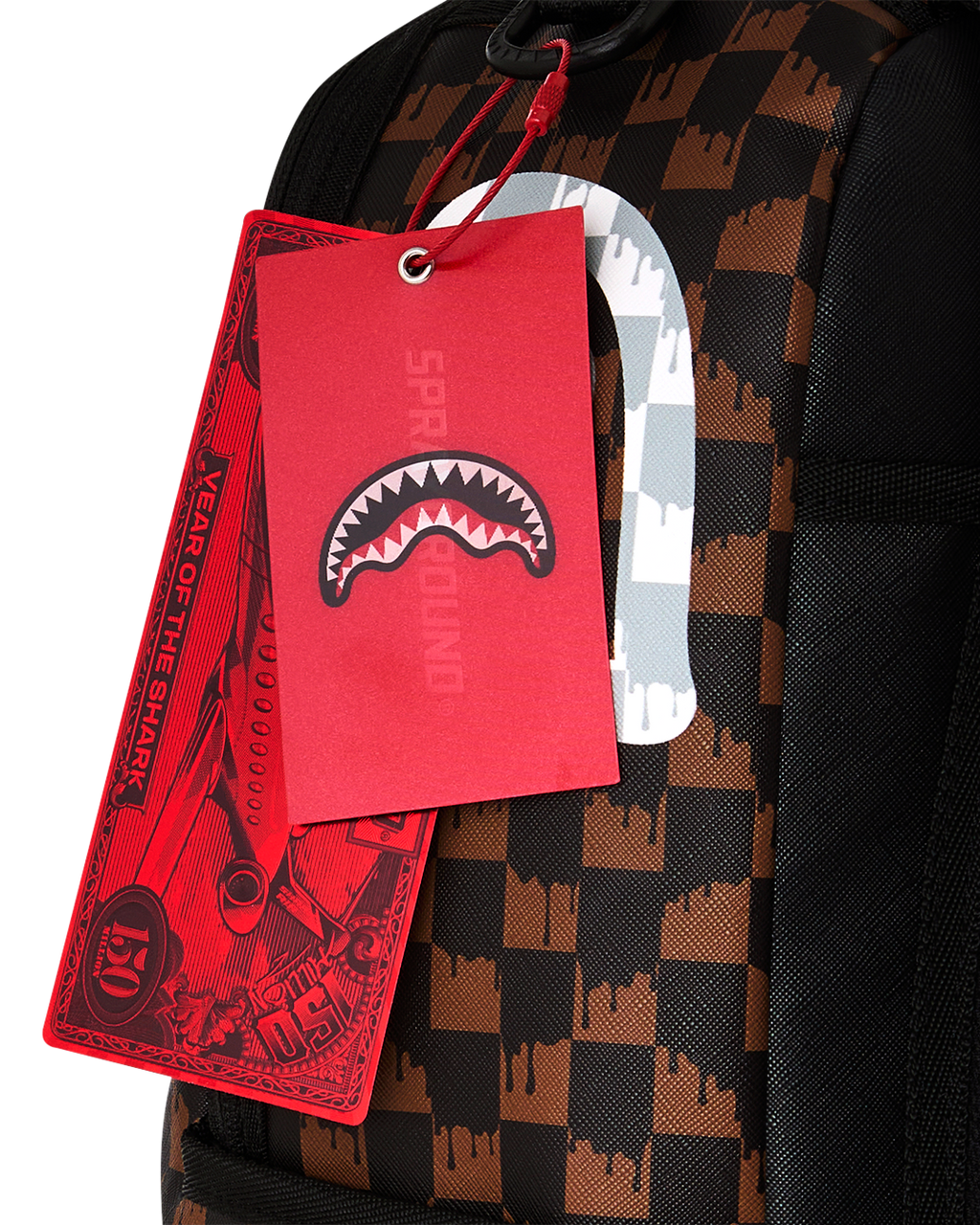 Fang backpack bag with brown black check pattern and red hanging tag