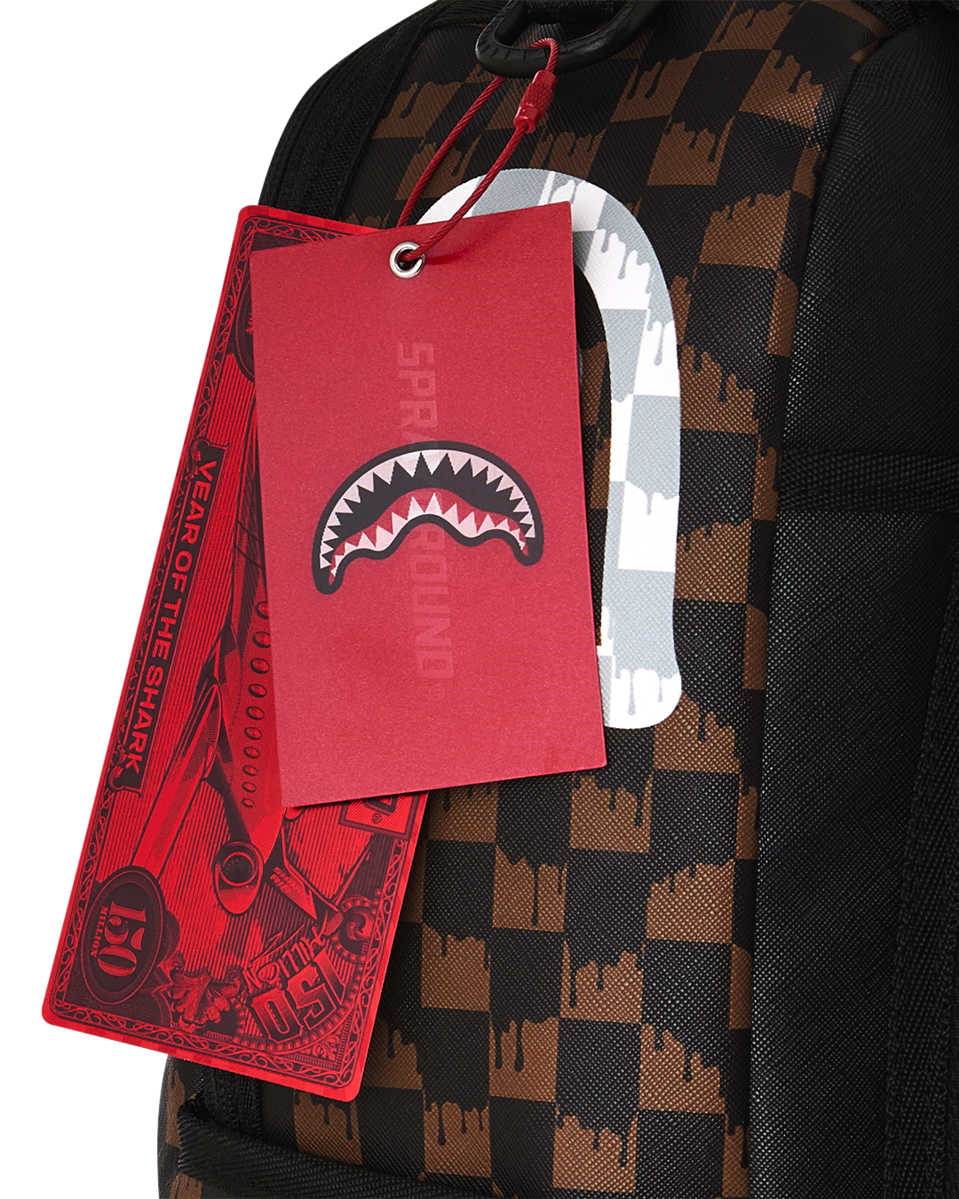 Fang backpack bag with brown black check pattern and red hanging tag